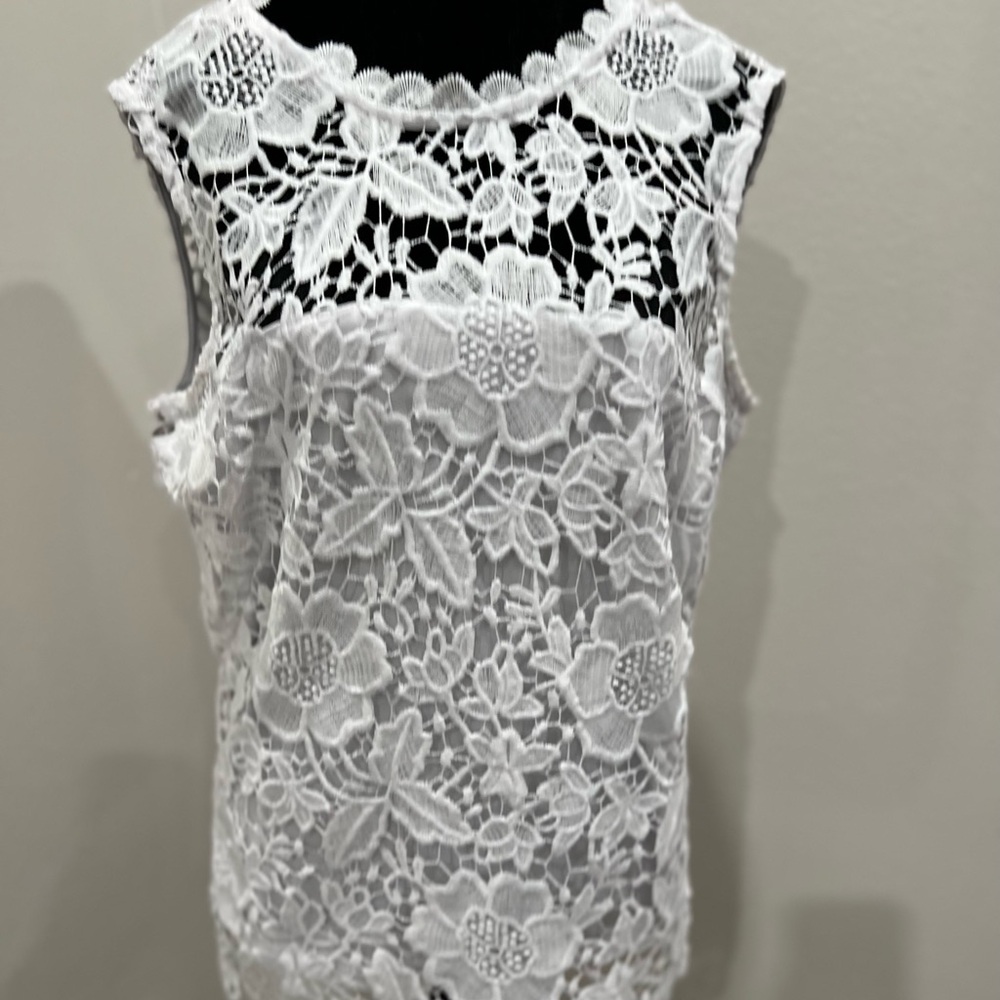 Bright white, sleeveless, top.  Great by itself or as a shell.